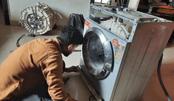 Revamp technician repairing front load washing machine in Pimple Saudagar, Chinchwad